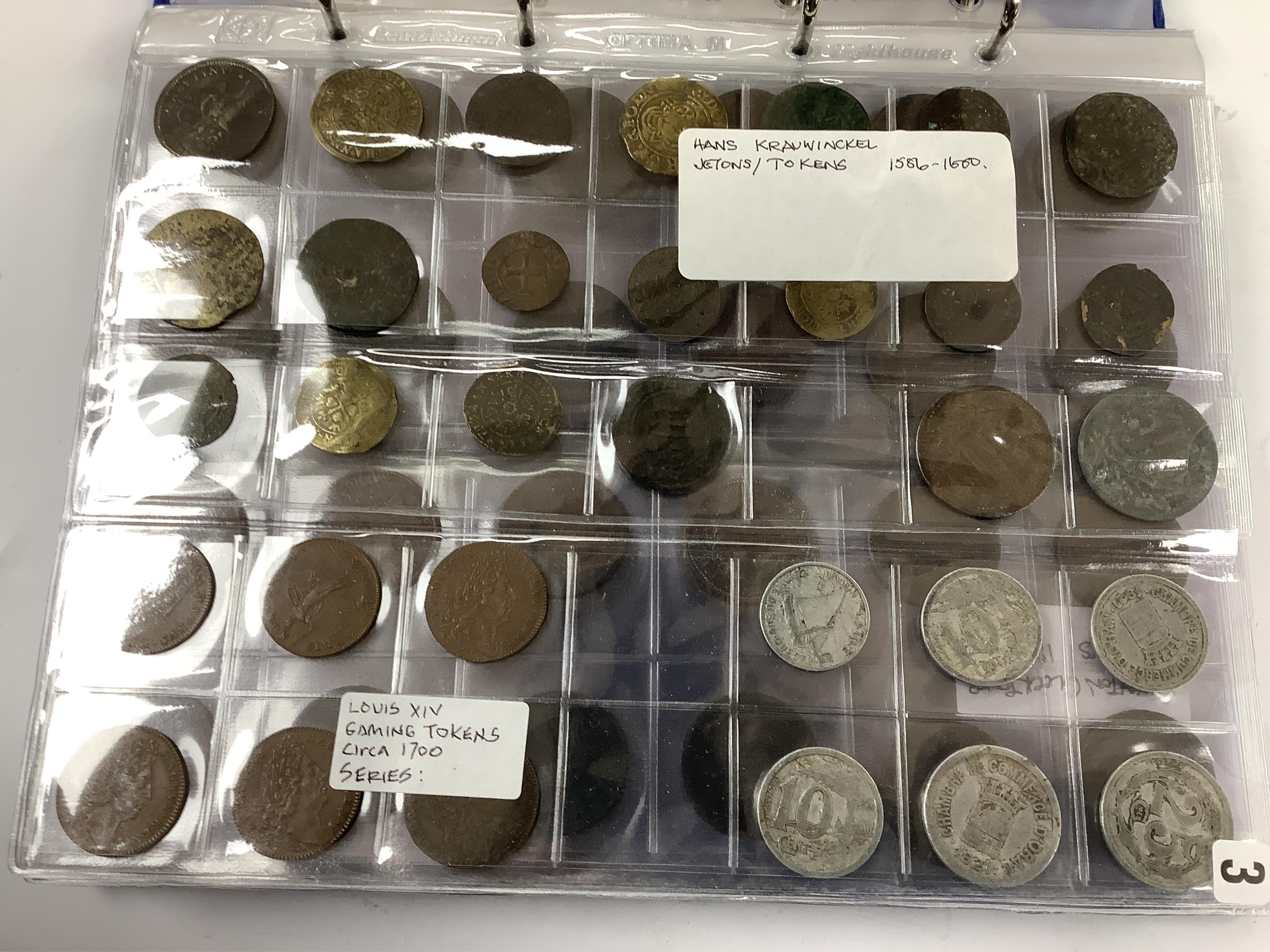 A large collection of halfpenny tokens and gaming tokens, 17th to early 20th century, in an album